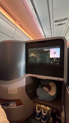 the inside of an airplane with shoes and other items on it's side shelves