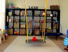 a child's play room with toys and bookshelves