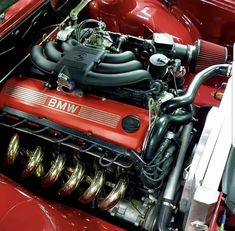 the engine compartment of an old red car