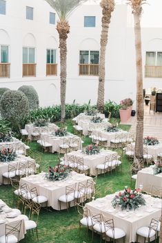 tables and chairs are set up for an outdoor wedding reception with palm trees in the background