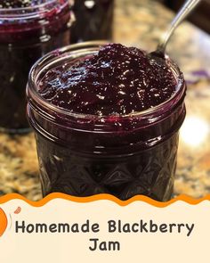 homemade blackberry jam in a glass jar with a spoon on the side and an orange label that says homemade blackberry jam