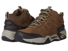 SKECHERS Arch Fit Recon - Romar - Men's Shoes : Khaki : Ensure comfort and style all day long wearing these SKECHERS Relaxed Fit Arch Fit Recon - Romar shoes featuring a waterproof upper and Goodyear Performance outsole. Waterproof leather and mesh upper. Textile lining. Removable SKECHERS Arch Fit insole system with podiatrist-certified arch support that reduces shock and increases weight dispersion. Relaxed Fit for a roomy comfort fit at toe and forefoot. Mid-top trail hiker design. Lace-up cl Skechers Sandals, Brown Leather Sneakers, Camo Shoes, Skechers Relaxed Fit, Mens Skechers, Chukka Boots Men, Oxford Shoes Men, Mid Top, Skechers Shoes