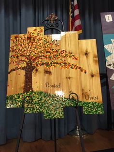 a wooden sign with an image of a tree on it