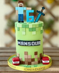 a cake that is made to look like a minecraft tower with two people on top