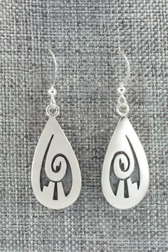 These sterling silver earrings are made by Hopi silversmith Timothy Mowa. The backs are signed and stamped sterling.Length: 1 5/8"Width: 1/2"Free shipping on all orders! We ship with USPS and always include tracking. All orders ship within a day of payment.Returns are accepted up to 30 days after you receive your order. Just send us a message. Our shop offers cash back or store credit. The item must be returned in new condition. Engraved Teardrop Sterling Silver Earrings, Silver Engraved Teardrop Earrings, Sterling Silver Teardrop Jewelry Stamped 925, Symbolic Hallmarked Sterling Silver Earrings, Artisan Teardrop Earrings Stamped 925, Silver Casting, Native Jewelry, Silver Earrings Dangle, Native American Jewelry