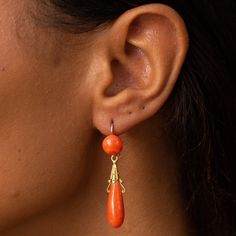 The Story These are a gorgeous pair of antique dangle earrings with lovely color and movement. Made during the Victorian era in France, each earring has two coral cabochons, a round piece at the top, and an elongated teardrop shape piece at the bottom. The bottom pieces are independently attached, giving them movement and swing with the wearer. The gold is warm and buttery and has detailed Etruscan Revival elements. Complete with French hallmarks, they hang 1.83 inches long and look incredible o Victorian Cabochon Drop Earrings, Orange Pierced Earrings For Formal Occasions, Orange Dangle Earrings For Formal Occasions, Formal Orange Pierced Earrings, Elegant Orange Pierced Earrings, Elegant Orange Drop Earrings, Orange Formal Earrings, French Victorian, The Victorian Era