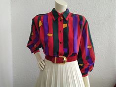 80s red blouse, striped color block top, spring blouse, large sleeve, pop-art blouse, long sleeve, 40 size, colorful holiday shirt, boho summer top.  vintage items always show signs of being worn  please check the measurements before ordering  Measurements laying flat : shoulders :43 cm (17inches)  armpit to armpit :59 cm (23 inches)  total lenght :68 cm (26,5 inches)  sleeve lenght :52 cm (20,5 inches) Retro Color Block Long Sleeve Tops, Retro Long Sleeve Color Block Tops, Red Retro Long Sleeve Top, Red Retro Summer Blouse, Retro Red Long Sleeve Top, Bold Long Sleeve Summer Blouse, Multicolor Long Sleeve Vintage Blouse, Long Sleeve Color Block Blouse For Summer, Summer Color Block Long Sleeve Blouse