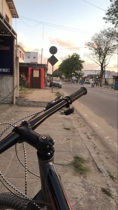 a bicycle parked on the side of a street