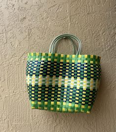 This gorgeous pvc plastic woven bag is the perfect summer pop of color to add to all your outfits!  Take to the beach, use as magazine storage, or on a shopping trip!  Shape and sizes vary given the handmade nature- some pieces may change shape depending on what is held in them. Green Square Straw Bag For Vacation, Trendy Green Handmade Straw Bag, Yellow Woven Beach Bag For Shopping, Green Beach Bag With Braided Handles For Shopping, Trendy Green Woven Beach Bag, Casual Green Rectangular Straw Bag, Casual Green Woven Beach Bag, Handmade Green Beach Bag For Vacation, Green Woven Square Straw Bag