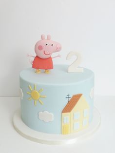 a peppa pig birthday cake with the number two on top