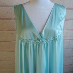 Seafoam Green Vintage Nightgown 3XL Absolutely beautiful color , silky and satiny Like a cool summer breeze this one is!! From Vanity Fair XXXL- tag size Material~ Nylon Find a garment you love, lay it flat and measure it, then compare! All measurements taken lying flat Shoulder to shoulder- 17 inches Armpit to Armpit 24 inches Hips~ approx 29 inches Top of strap to bottom hem~ 36 inches This gown is in excellent condition. Last photo shows area of repair  gown has been laundered in mild plant-based detergent and tumbled dry Vintage clothing is over 20 years old and residual odors may be present even after the cleaning/laundering interventions that I have taken. You are buying the item in the photo All sales are final. Please reach out if you need another photo, measurement or have a quest Summer Satin V-neck Nightgown, Satin Finish V-neck Nightgown For Loungewear, Green Satin Sleepwear For Summer, Satin V-neck Summer Nightgown, Satin Finish V-neck Sleepwear, V-neck Nightgown With Satin Finish For Loungewear, V-neck Satin Finish Nightgown For Loungewear, Summer Satin V-neck Sleepwear, Sleeveless Satin Nightgown For Summer