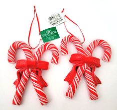 two red and white candy canes tied to each other with a price tag on them