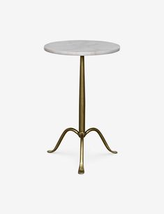 a white marble table with gold metal legs