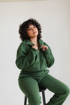 Forest green quarter zip up and matching joggers. This pullover features a gold zipper and relaxed, cropped fit. The joggers are slim fitting with a straight leg. Athleisure Half-zip Sweater For Loungewear, Relaxed Fit Half-zip Sweatshirt For Loungewear, Half-zip Sweatshirt With Zipper For Loungewear, Half-zip Sweatshirt With Zipper Closure For Loungewear, Zipper Closure Long Sleeve Sweatshirt For Loungewear, Long Sleeve Sweatshirt With Zipper For Loungewear, Relaxed Fit Half-zip Hoodie For Loungewear, Half-zip Loungewear Hoodie, Zipper Closure Sweatshirt For Fall Loungewear