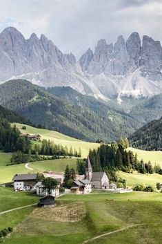 an alpine village surrounded by mountains and trees