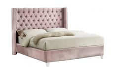 a bed with a pink velvet headboard and foot board