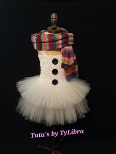 This adorable Snowgirl tutu dress is perfect for a Holiday party, Halloween costume or just for fun! This tutu dress is made with 2 layers of fluffy white tulle plus white glitter tulle mixed throughout the top shorter layer - just to add some sparkle, a white stretch crochet top embellished with black glitter buttons and thin white ruffle shoulder straps that tie around the neck.  ** SCARF IS A PHOTO PROP AND NOT INCLUDED IN THE LISTING ** When ordering select the child's clothing size or send Snowman Costume, Stretch Crochet, Crochet Tube Top, Snow Girl, White Tulle, Party Halloween, Neck Scarf, White Glitter, Tutu Dress