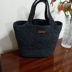 Hand knitted from 2 layers of yarn with a floss raffia mixture. It was knitted using the single needle method. The handle is knitted together with the bag. There is careful workmanship. It can accompany both your sports and stylish clothes. It is comfortable to use. Thanks to its large volume, you can carry many of your belongings in it. It is lightweight and very useful. In addition to using it when going to an evening party, you can also use it comfortably in your daily life. Its height is 28 cm and base width is 36 cm. Casual Hand-knitted Yarn Bag, Casual Hand Knitted Rectangular Straw Bag, Casual Hand-knitted Rectangular Straw Bag, Casual Rectangular Hand Knitted Straw Bag, Casual Crochet Straw Bag For Daily Use, Casual Crochet Straw Bag Made Of Yarn, Natural Knitted Straw Bag For Daily Use, Casual Crochet Yarn Bag With Braided Handles, Casual Handmade Black Straw Bag