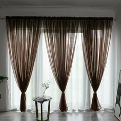 a living room filled with furniture and curtains