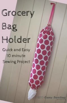 the grocery bag holder is made from fabric and has a pink polka dot pattern on it