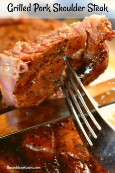 grilled pork shoulder steak on a plate with fork