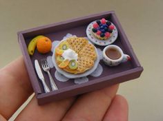 a miniature tray with some food on it