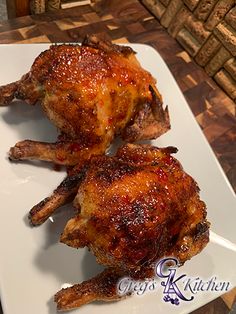 two pieces of chicken on a white plate