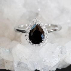 Natural Black Onyx Pear Stone, Carefully crafted into Solid Gold, Purity and Color of your Choice and a D color Moissanite Stone Halo made to order Gemtype: Natural Black Onyx Main stone size: 6x8mm Stone clarity:vvs Side Stone: D color moissanite Metal Type: 10k , 14k and 18k Gold Color of your choice Metal Stamp: 10k, 14k and 18k according to your choice Stone Origin: India Center stone can be personalized at your request, get in touch with us to create your dream ring. Packaged in a gift read Black Stone Ring Engagement, Black Gemstone Ring, Engagement Ring Black, Black Stone Ring, Black Engagement Ring, Pear Ring, Ring Black, Gold Engagement Ring, Birthday Gift For Her