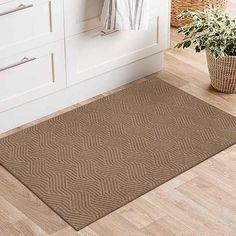 a brown rug in a bathroom next to a sink