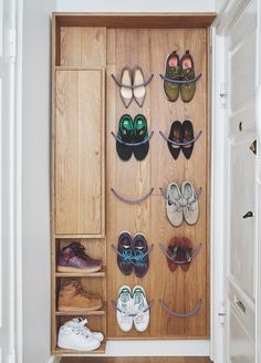 there are many pairs of shoes hanging on the wall