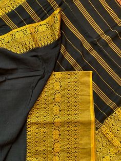 This is an original Begampuri cotton saree in a striking black and mustard yellow combination. Simple, comfortable and elegant are the right three words to describe this six yards. This saree is named after the town it is woven in- Begampur is a small town famous for its saree weaving in the Hooghly district of West Bengal.  These sarees can be identified by their loosely woven, light-weight and translucent make and have contrasting borders in red, black, purple, orange etc. Weavers use a pit lo Black Cotton Silk Traditional Wear With Dupatta, Black Cotton Silk Saree For Diwali, Unstitched Black Cotton Silk Saree, Black Dupatta With Border In Traditional Drape, Black Cotton Silk Dupatta For Diwali, Unstitched Black Saree With Border, Black Handloom Traditional Wear For Puja, Black Dupatta With Border, Festive Black Dupatta With Weaving Work