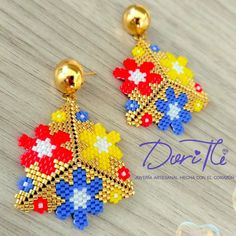 the beaded christmas tree earrings are made with different colors and shapes, including red, white, blue, yellow, and green beads