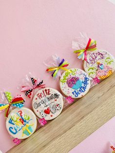 decorated birthday cookies on a shelf in a girls'room with pink walls and decorations