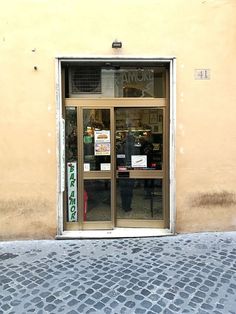 an open door to a store with signs on it