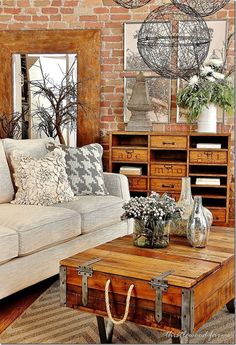 a living room filled with lots of furniture next to a wall covered in mirrors and vases