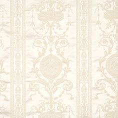 a white and beige wallpaper with an ornate design on the back side of it