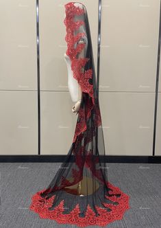 a mannequin wearing a red and black dress