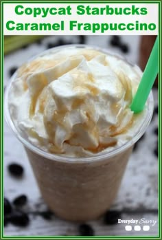 a close up of a cup of food with whipped cream on top and a green straw