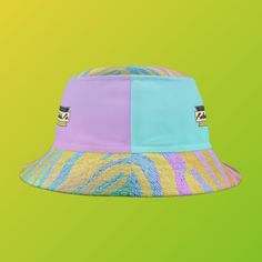 Looking for a fun and stylish way to enjoy the sun? Look no further than the Kolohe Ko brightly colored pastel tiger print bucket hat! Featuring the words "Just Beachy Keen" written inside a Honu (Turtle) graphic on the front, this hat is perfect for anyone who wants to stand out and have some fun in the sun. Originally designed to protect fishermen from rain in the 1900s, the bucket hat has now become a top fashion pick for all ages. This hat is comfortable and durable, made from 100% polyester Trendy Multicolor Bucket Hat For Outdoor, Trendy Bucket Sun Hat For Summer, Trendy Multicolor Sun Hat For Outdoor, Retro Multicolor Bucket Hat For Summer, Multicolor Bucket Sun Hat For The Beach, Multicolor Bucket Hat For The Beach, Retro Multicolor Sun Hat For Summer, Trendy Multicolor Bucket Hat For Beach Season, Multicolor Bucket Hat For Beach