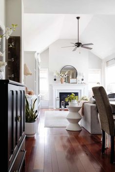 a living room filled with furniture and a fire place in the middle of a room