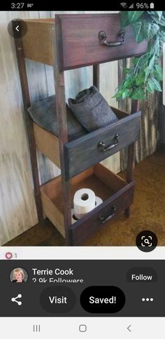 an old wooden table with two drawers and some toilet paper on it's shelf