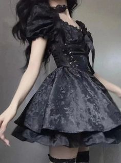 This Cute Gothic Puffy Dress is a beautiful amalgamation of sweet Lolita charm and gothic allure. The dress features puffed sleeves that can be worn off-shoulder for a romantic look, while the fitted bodice is accentuated with corset-like lacing that offers both an elegant silhouette and an adjustable fit. Its luxurious black fabric is patterned with subtle floral lace, adding depth and texture. The skirt flares out into a playful, yet sophisticated bell shape, finished with a ruffled hem that e Unique Clothing Stores, Fitted Corset, Rash Guard Swimwear, Puffy Dresses, Dream Dresses, Veil Brides, Black Veil Brides, Black Veil, Romantic Look