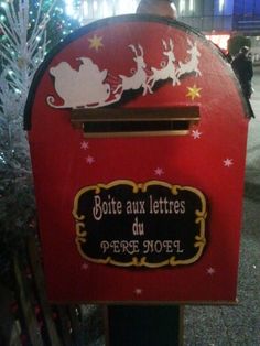 a red mailbox with santa's sleigh on it