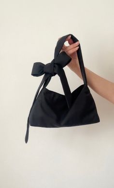 Black  Small  padded shoulder bag with tie up closure and bow on the shoulder. Adjustable straps. you can wear this bag on your shoulder or as crossbody bag. Made from organic vintage cotton. This bag is attributed to its timeless, versatile design. Would look cute with any outfit. It's sustainable and chic to retro aesthetics. We use our own patterns and designs. if you would like a different size please message us we can create a custom listing. Size Height 7 inches  width 10 inches  Debth 3 i Black Shoulder Bag With Bow, Cute Bags Aesthetic, Vintage Bag Pattern, Fabric Bag Design, Bow Clothing, Mini Bag Pattern, Bag Customization, Shoulder Bag Pattern, Aesthetic Bag