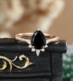 a black diamond ring sitting on top of a wooden table