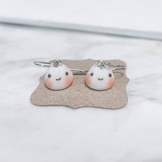 This is a listing for a pair of cute bao earrings! Just like the ones you would find at dim sum, these are the perfect accessory for any occasion. They come with stainless steel earring hooks! Stainless steel bao studs are available in my shop here: https://www.etsy.com/listing/1247789886/dim-sum-earrings-pork-bun-bao-polymer?click_key=fad7ad160f2d0a2d64eefee454163d2700e03eb6%3A1247789886&click_sum=0515cdf2&ref=shop_home_active_2 ♡ D I M E N S I O N S ♡ ❤ ~0.4 in. Length x ~0.4 in. wide ♡ C A R E ♡ ❤ Our charms are all handmade and should be handled with care ❤ This is NOT a toy and should not be given to young children ❤ Please also note that due to monitor differences, actual colors may vary  ❤ Made to order, actual item may vary  ♡ S H I P P I N G ♡  ❤ All packages will be shipped in a Nickel Free Novelty Earrings For Everyday Wear, Handmade Silver Kawaii Earrings, Handmade Kawaii Silver Earrings, Kawaii Hypoallergenic Drop Earrings, Nickel-free Kawaii Earrings For Gifts, Nickel-free Kawaii Earrings As Gift, Silver Hypoallergenic Kawaii Earrings, Cute Tiny Earrings For Everyday, Hypoallergenic Silver Kawaii Earrings