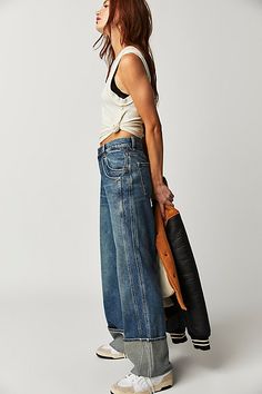 So slouchy and cool, these jeans from our We The Free collection are the perfect off-duty pair. **Fit:** Low-slung, slouchy wide-leg silhouette designed to be worn low on the hips **Features:** Six-pocket design, sewn cuffed hemlines, zip fly and button closure, lightweight rigid denim **Why We ❤ It:** Effortless with a baby tee or elevated with a billowy blouse, this pair has endless ways to wear. | We The Free Final Countdown Cuffed Low-Rise Jeans at Free People in Medium Wash, Size: 29 S Final Countdown, Chic Blazer, Stretch Denim Fabric, All Jeans, Denim Day, Denim Branding, Low Rise Jeans, Mid Rise Jeans, Bottom Clothes