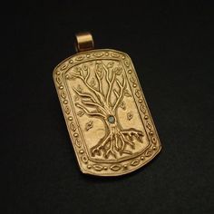 This tree of life necklace is hand carved and shaped into a military dog tag which makes it perfect for a husband gift and unique for a nature lover.The tree of knowledge, connecting to heaven and the underworld, and the tree of life, connecting all forms of creation, are both forms of the world tree or cosmic tree, and are portrayed in various religions and philosophies as the same tree.• Hand sculpted pendant• Solid yellow bronze also called jeweler gold bronze.• Embedded 2 mm natural peridot Spiritual Engraved Dog Tag Jewelry, Engraved Bronze Nature-inspired Jewelry, Nature-inspired Engraved Bronze Jewelry, The Tree Of Knowledge, Military Dog Tag, Tree Of Knowledge, Military Dog, Dog Tags Military, Dog Tag Pendant