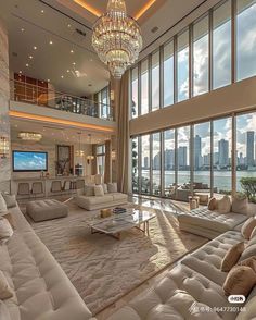 a large living room with high ceilings and floor to ceiling windows overlooking the city skyline