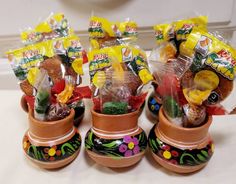 four flower pots filled with candy and candies